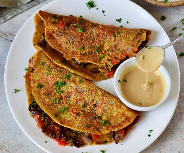 2-vegan-omelette-on-white-plate-with-creamy-dressing